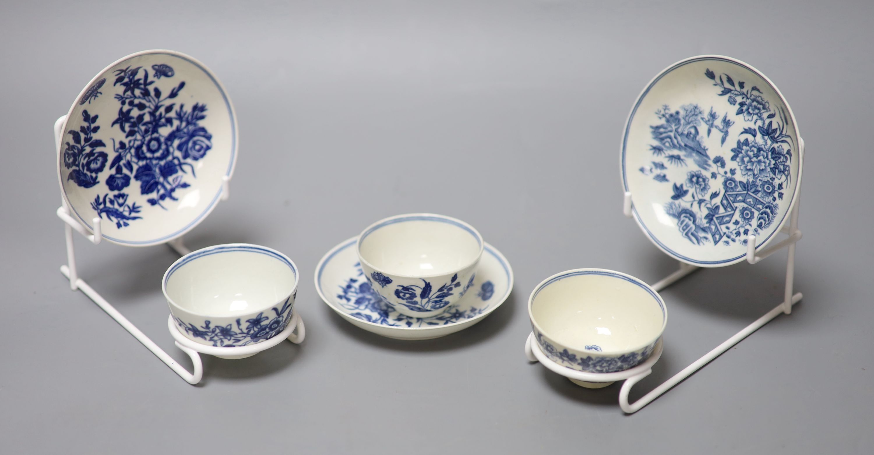 Three 18th century Worcester tea bowls and saucers, two printed with Three Flowers and one printed with the Fence pattern most with cre